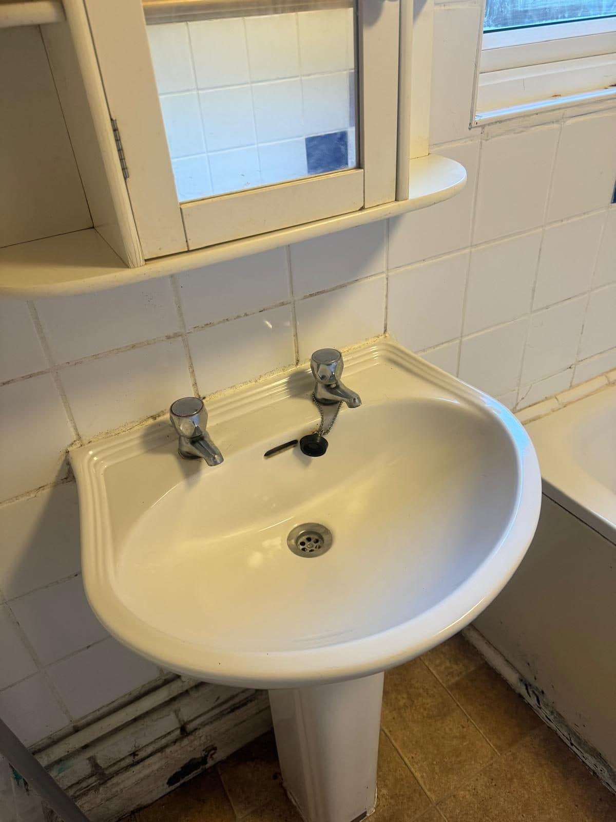 The basin after cleaning, bright white with clean taps